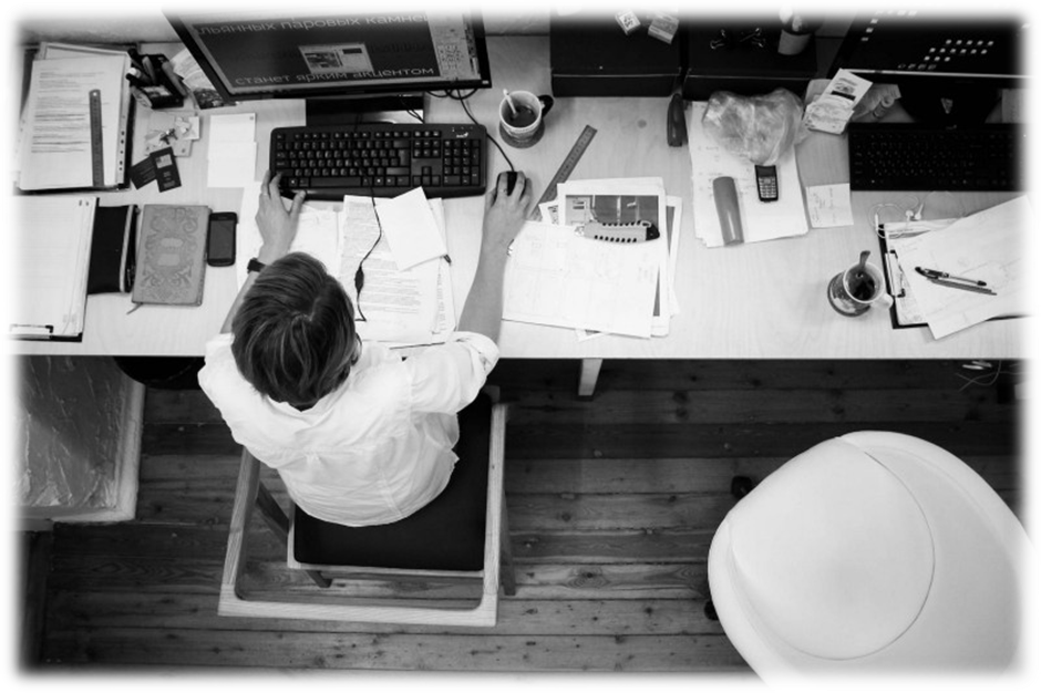 Overhead view of a man working on a computer in his workplace.