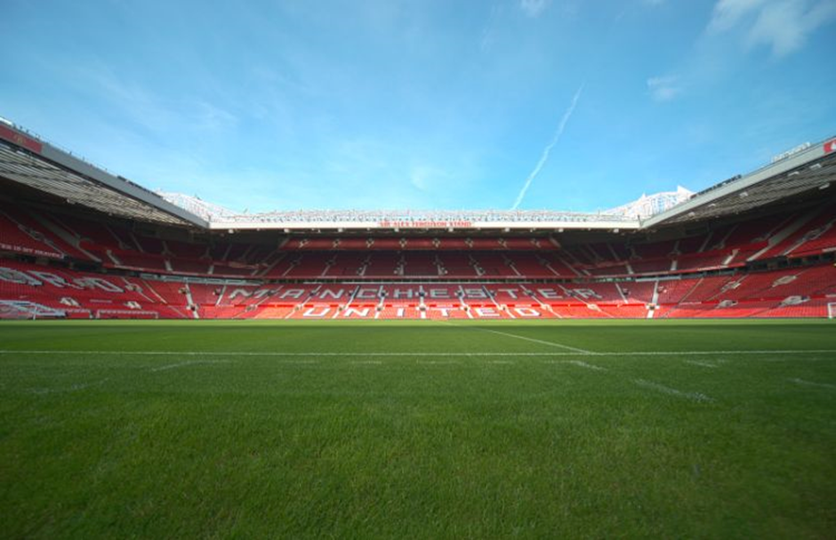 The green pitch of Old Trafford — home of Manchester United