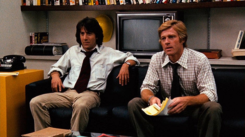 Still from the movie All the President’s Men. Dustin Hoffman and Robert Redford sitting on a couch.