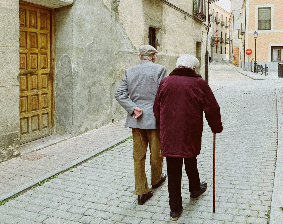 Old Couple Walking through Street