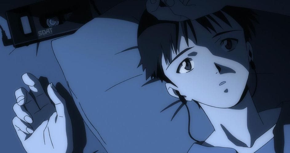 A boy with earbuds in lays on his pillow and looks up at the ceiling, looking sad.