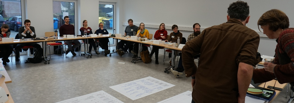 People sitting in a room and listening to a presentation.