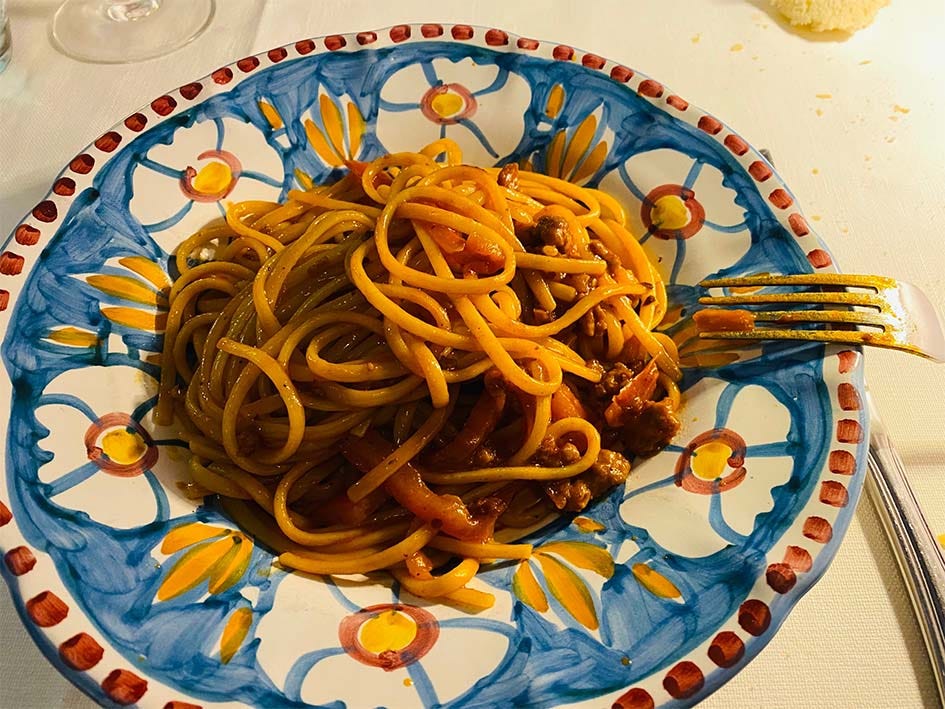 plate of pasta with red sauce in Modena Italy