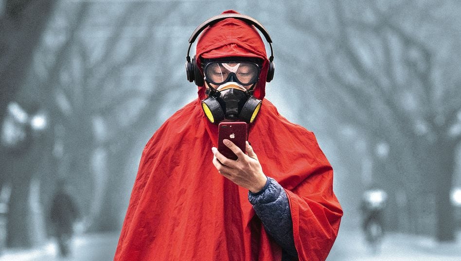 A man in full protective gear checks his phone