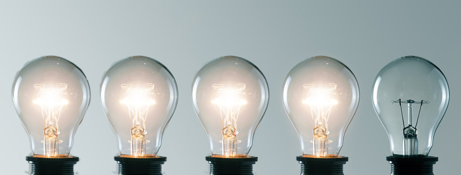 Image of four lit lightbulbs in an array of five.
