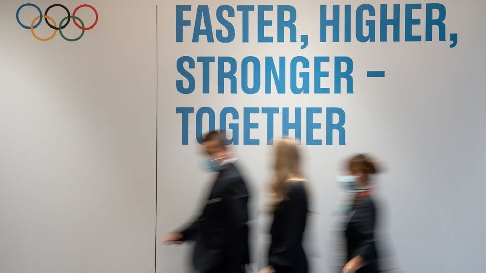 Olympic motto — “Faster, Higher, Stronger — Together”, written on a wall.