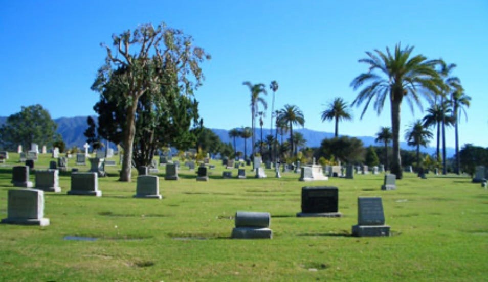 A picture of a cemetery on a beautiful day with a gorgeous blue sky in the background.