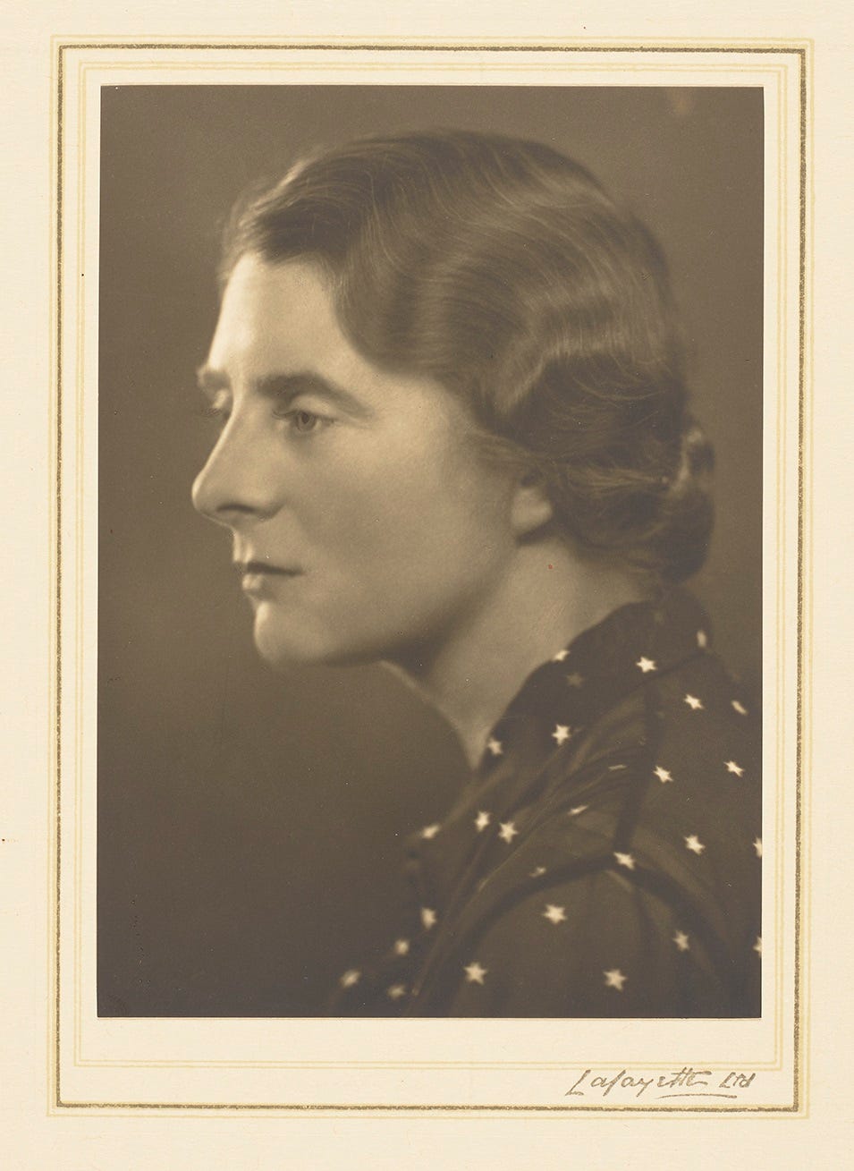Studio portrait photograph of Margaret Pilkington in profile wearing a blouse decorated with stars, c.1930s