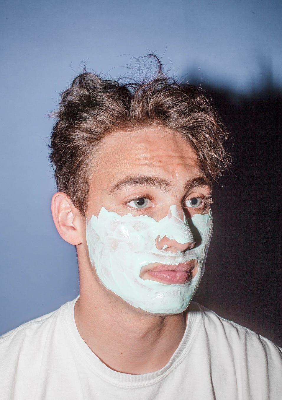 Man with skincare products on his face.