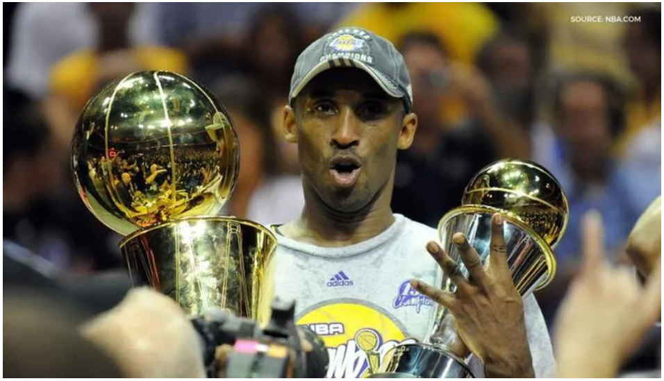 Kobe holding the Larry O’Brian trophy in 2009 and winning Finals MVP