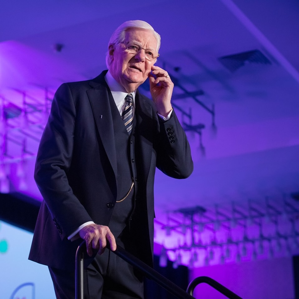 Bob Proctor on a stage, teaching