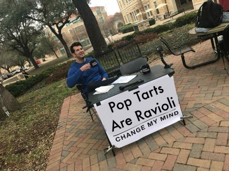 Change my mind meme image macro: a young man sits behind a table holding a mug. In front of him is a table and banner that says “Pop Tarts Are Ravioli — Change my mind”