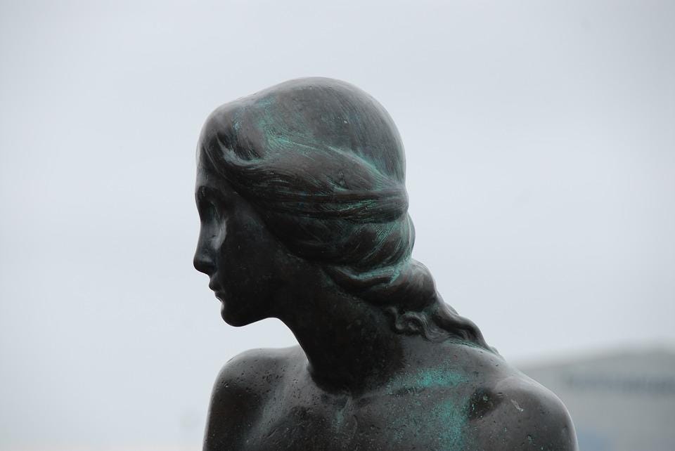 A photograph of the head and shoulders of The Little Mermaid statue in Copenhagen, Denmark.