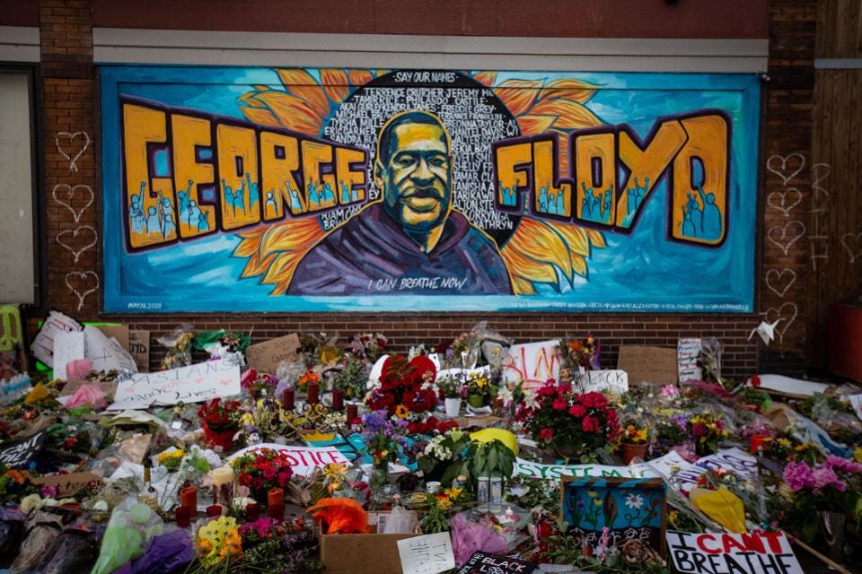 The George Floyd Mural now adorned with flowers by well wishers.
