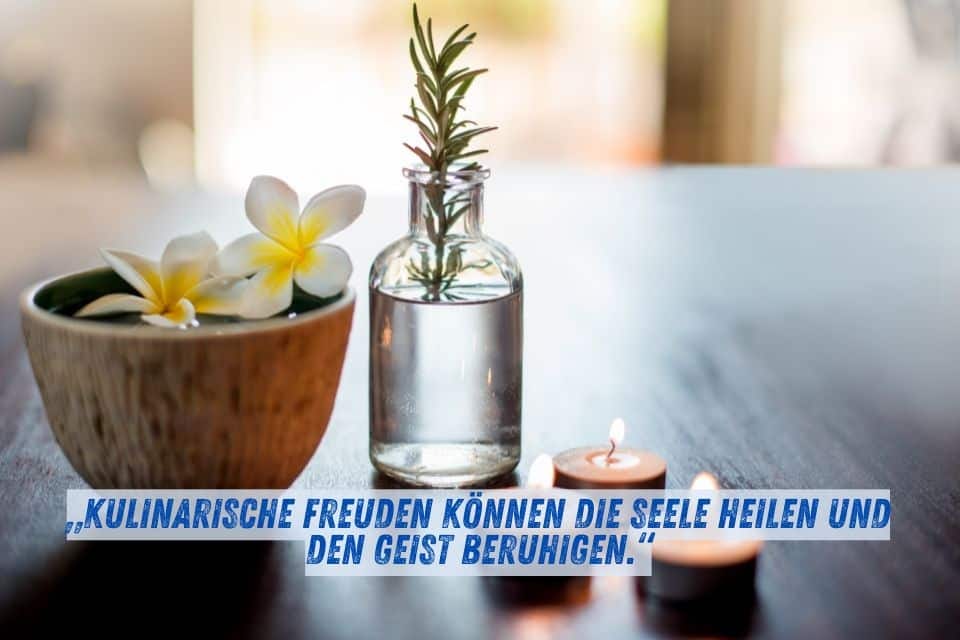 Das Bild zeigt eine entspannende Szene mit einer Schale, die Blüten schwimmen lässt, einer kleinen Flasche mit Kräutern und zwei brennenden Teelichtern. Darunter steht der Text: „Kulinarische Freuden können die Seele heilen und den Geist beruhigen.“