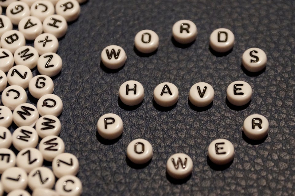 Letter tiles spelling out “Words Have Power”.
