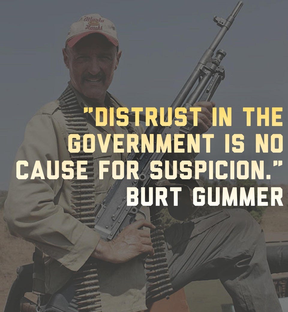 Burt Gummer from the movie Tremors holds a gun and the text says, Distrust in government is no cause for suspicion.” Burt Gummer