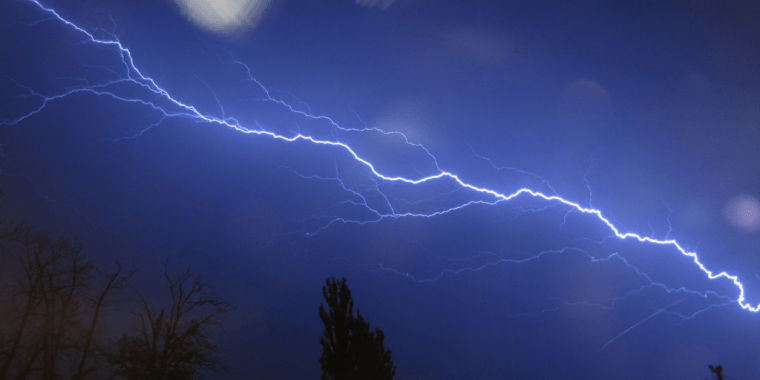 A bolt of lightning streaks across the sky.