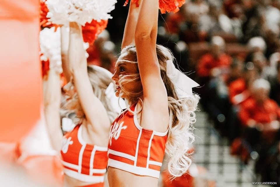 Sydney cheering on the sidelines during her time at Nebraska