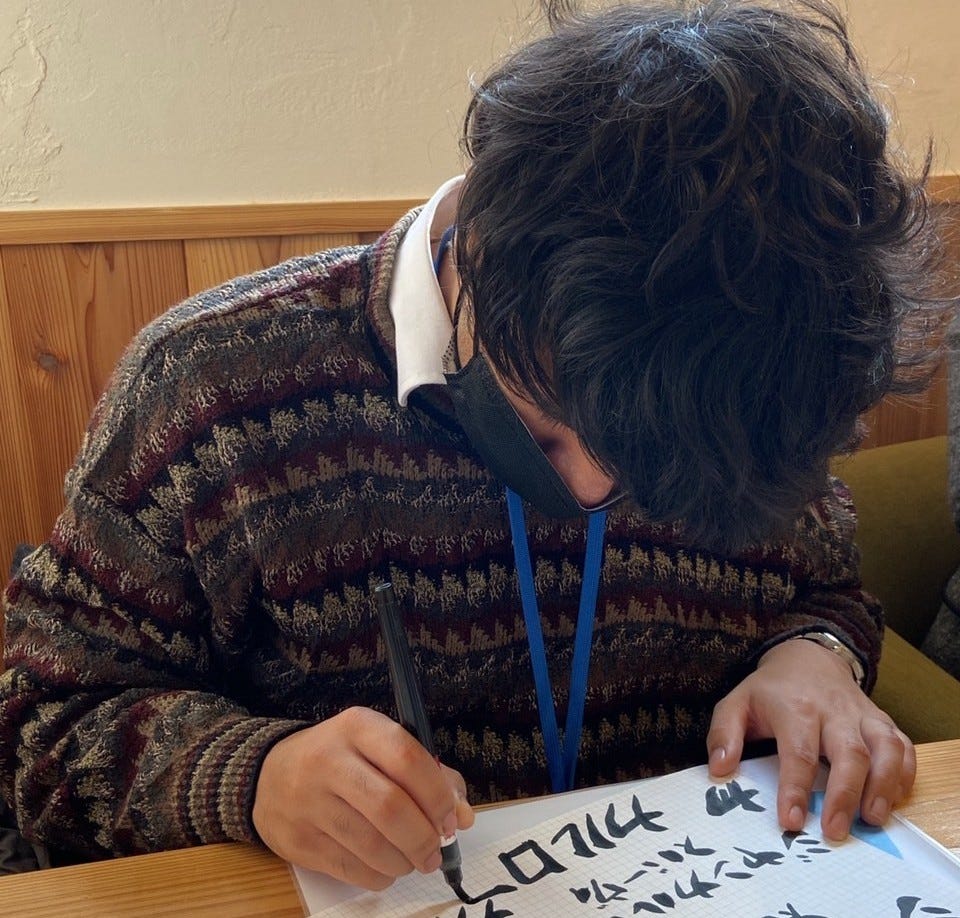 Giancarlo Subervi writing with a calligraphy pen