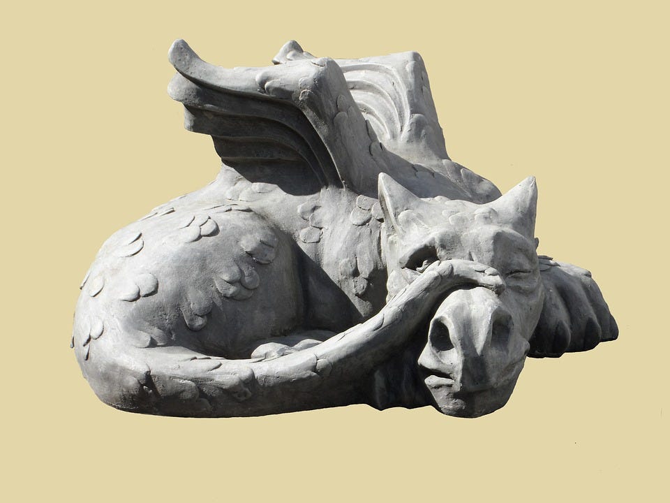 a stone sculpture of a dragon depicting jealousy