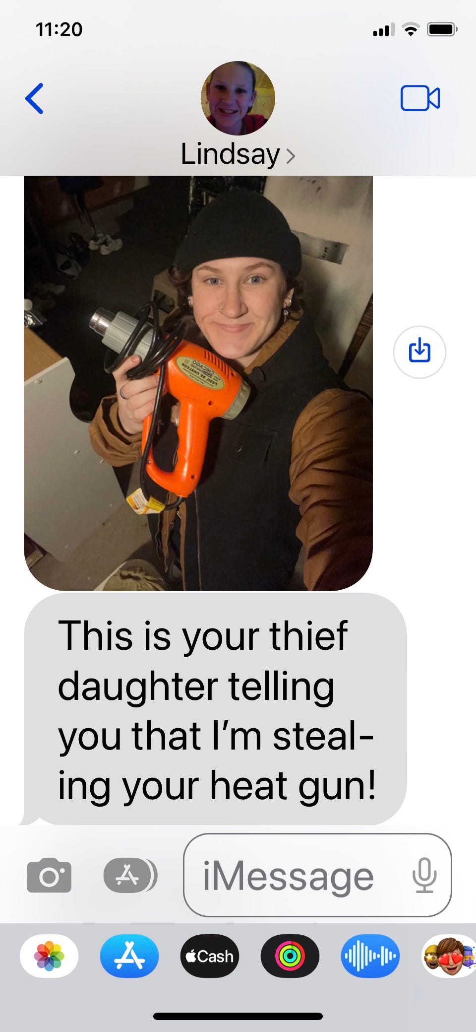 Screenshot of a text message on a phone accompanied by a picture of a young woman holding up a heat gun. The text reads, “This is your thief daughter telling you that I’m stealing your heat gun.”