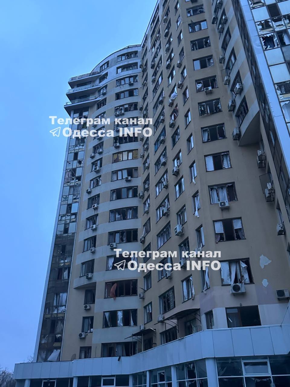 A civilian high rise apartment building with all of the windows blown out from the shockwave of a hypersonic missile launched by Russia.