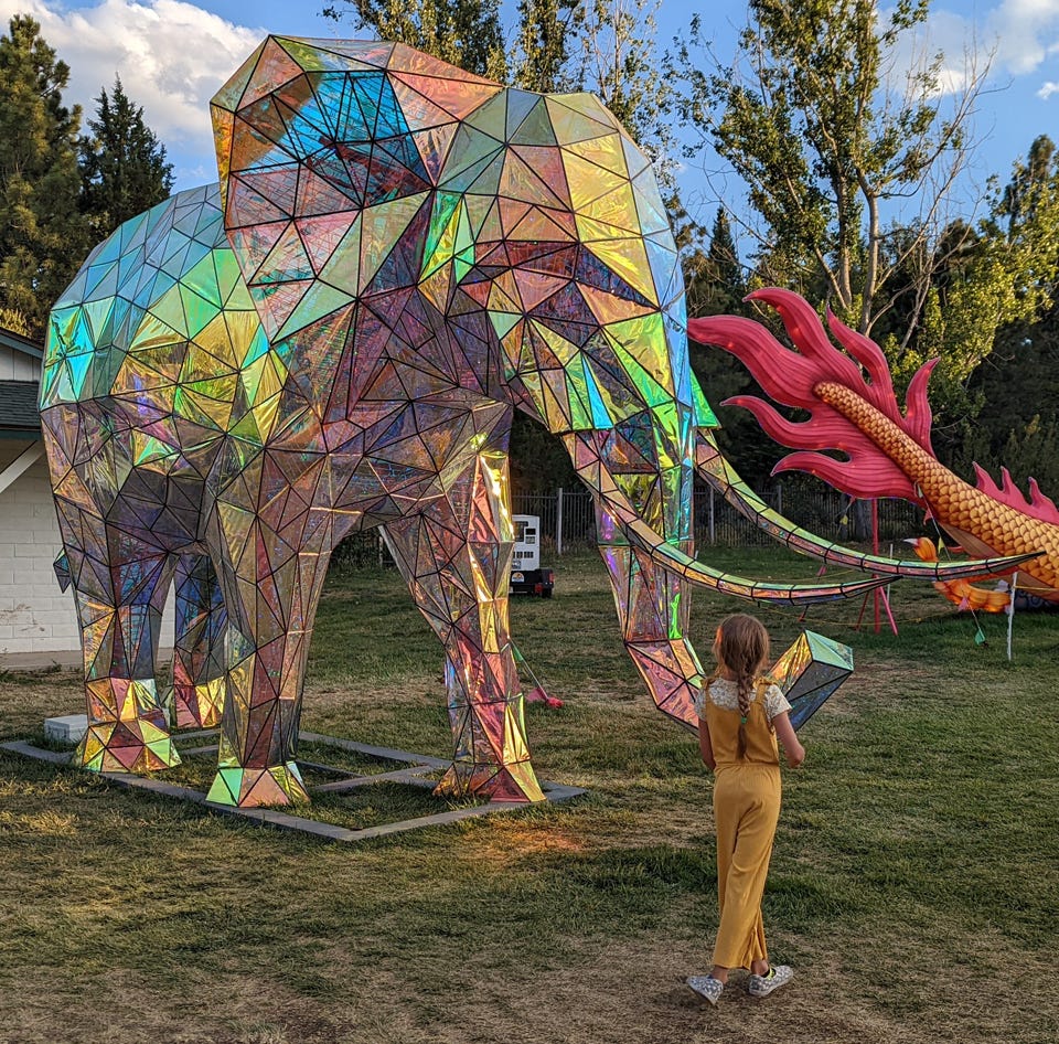 Girl meets elephant at Dragon Lights Festival in Reno, Nevada. (© Michael Kamerick)