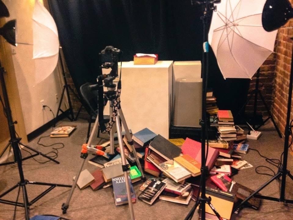 Photo studio with books toppled everywhere.