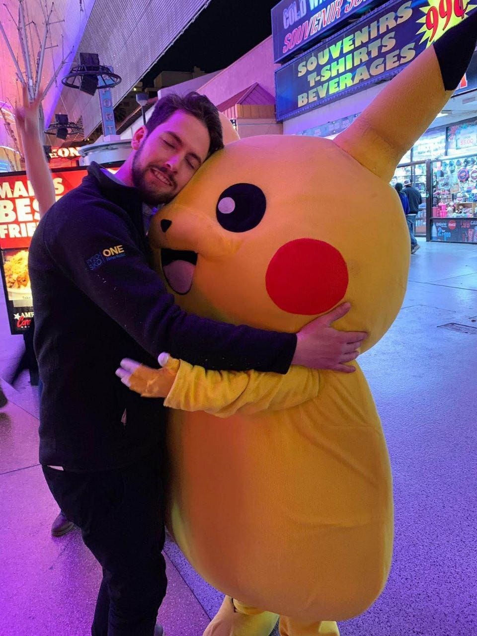 Sean Winters hugging someone dressed as Pikachu from Pokémon, in Las Vegas