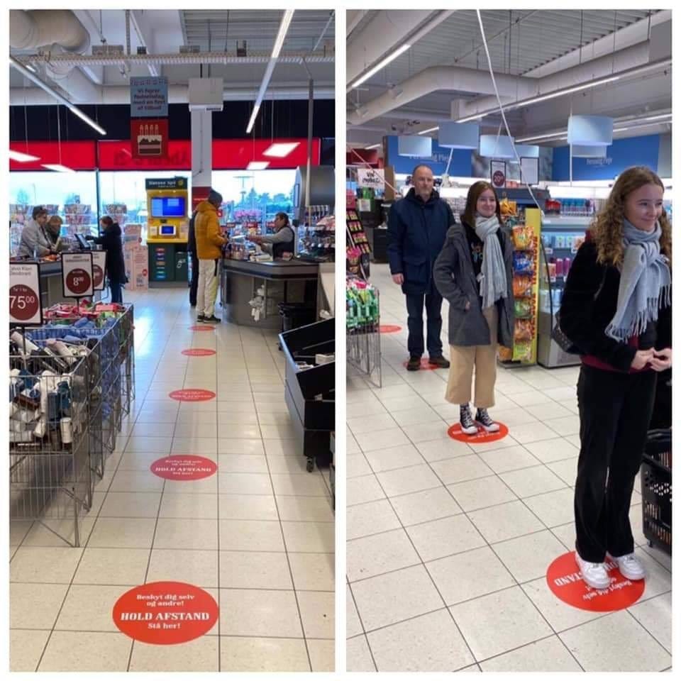 Red stickers on the floor help shoppers know where to stand in a supermarket in Denmark.