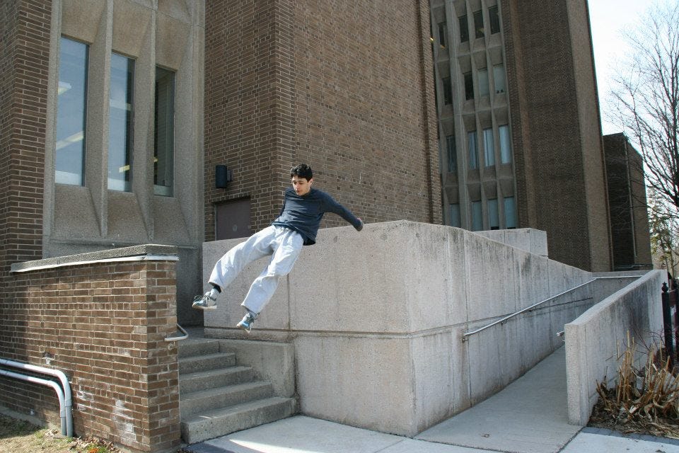 Muhammed Ebrar Aydin doing parkour. He is in the air about the land after doing a vault. LegendofEbrar. Muhammed Aydin.