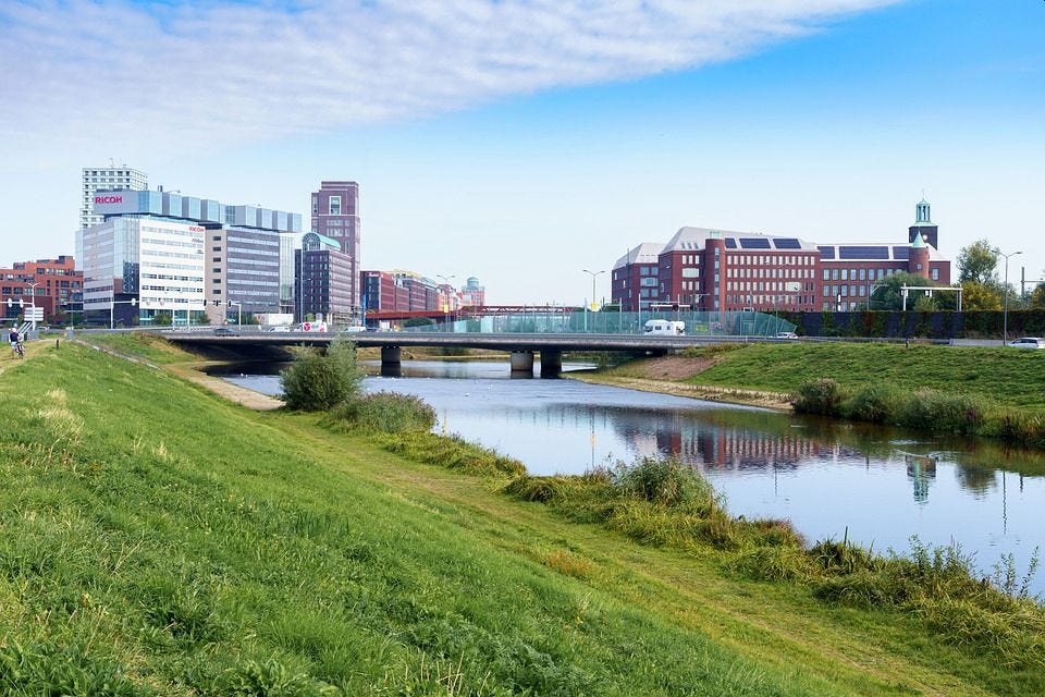 View across a waterway in Den Bosch with a bridge crossing it.