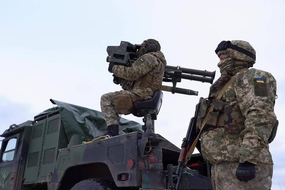 Two Ukrainian soldiers in a condition of high combat readiness.