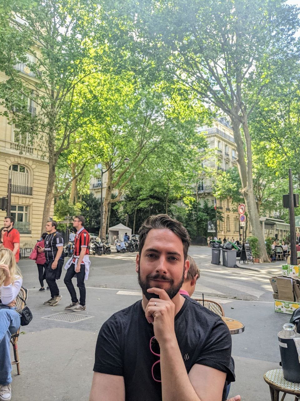 Sean Winters sitting outside a cafe on Avenue de la Bourdonnais in Paris