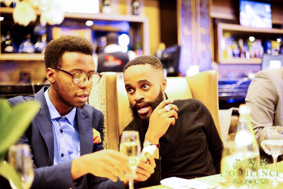 Two men talking at a dinner table.