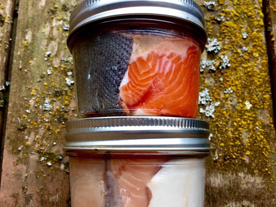 jars with salmon fillets inside