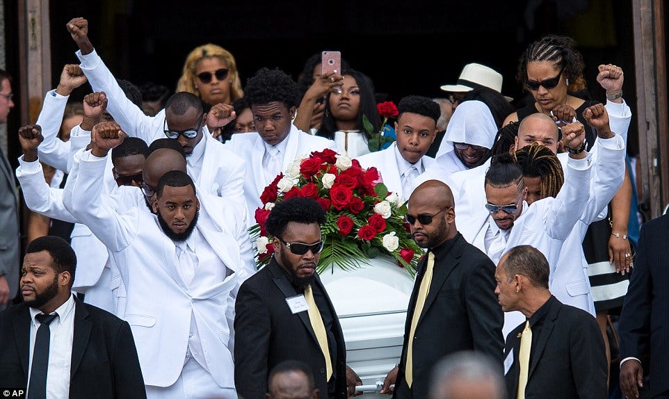 The body of Philando Castile is carried to his funeral by pallbearers making a Black Power salute.
