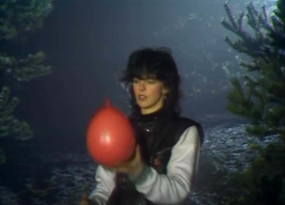 Screenshot of Nena holding the lone red balloon found in the wake of the destruction, and letting it go.