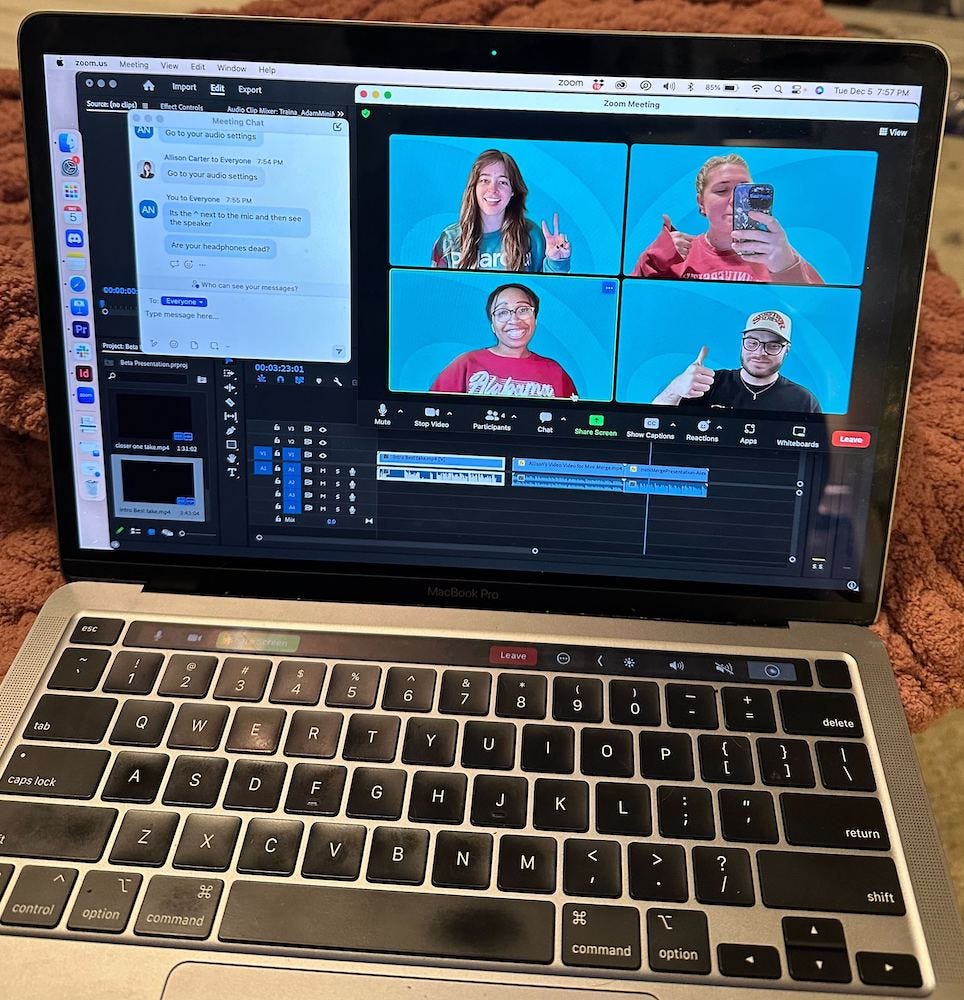 A computer with four people on a Zoom call on the screen.