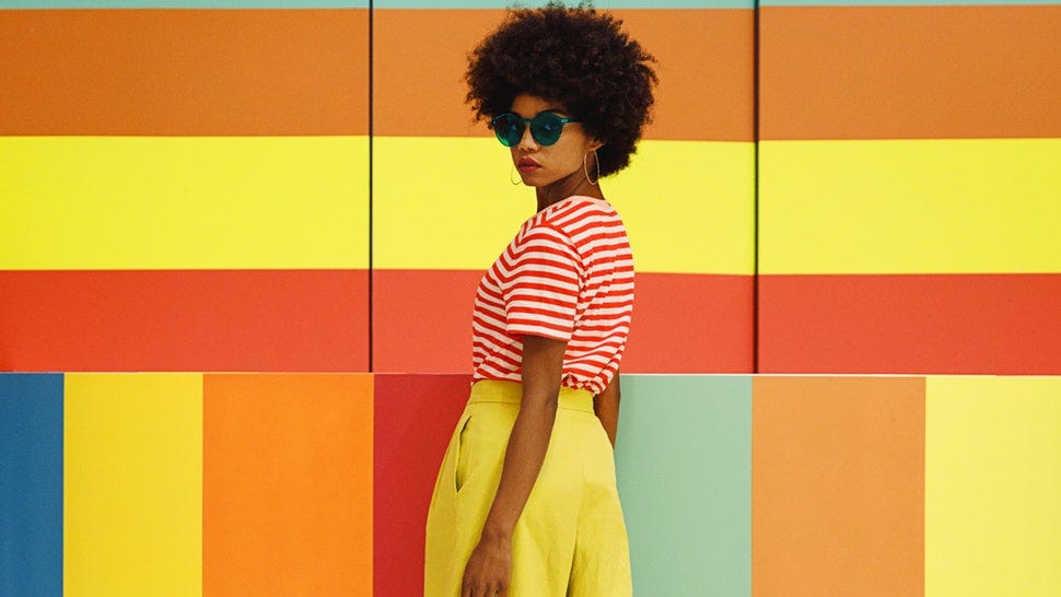 girl in front of a wall of colors.