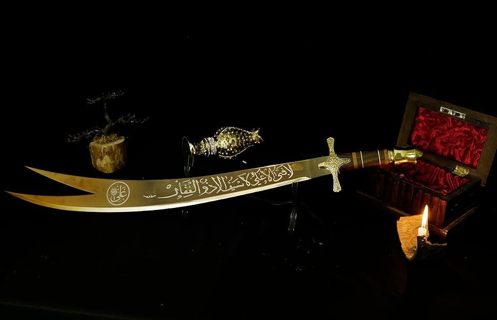Zulfiqar, the most powerful sword in history, resting on a stand. The double-pointed blade is adorned with intricate Arabic inscriptions.