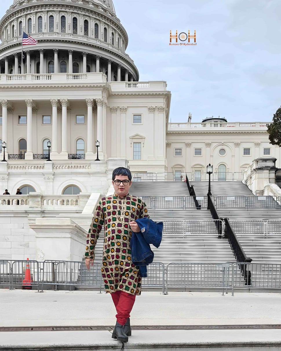 An adult poses in front of the United States Capitol building in Washington, DC.