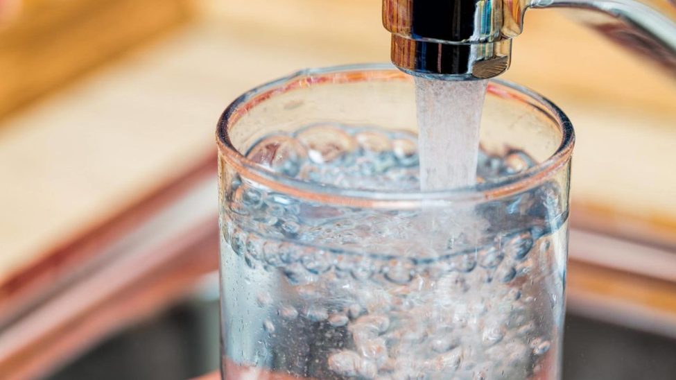 Filling drinking water in a glass from a tap