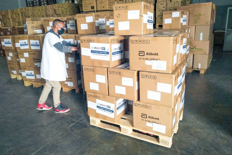 Medicines and health commodities are stored at and distributed from central medical stores. Here, staff receive a delivery of malaria rapid diagnostic tests funded by the U.S. President’s Malaria Initiative.