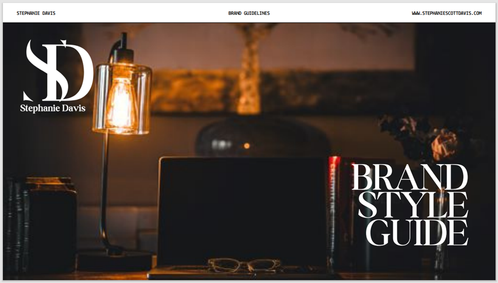 laptop with gold eyeglasses and lamp on wood desk