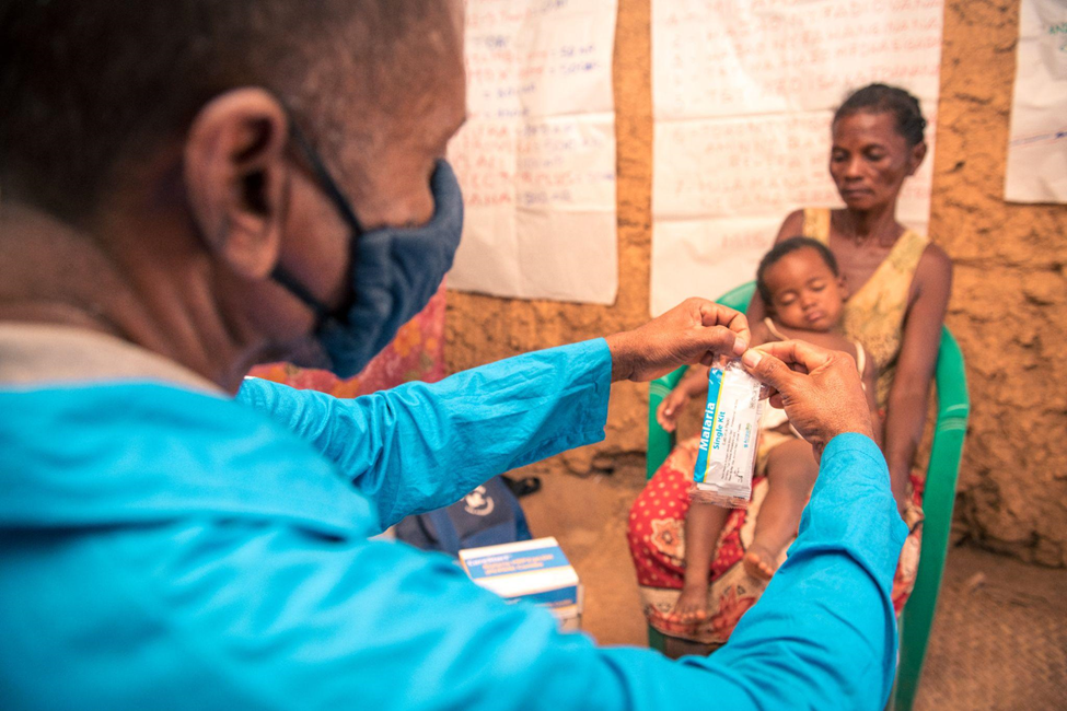 A nurse in Madagascar administers a rapid diagnostic test for malaria to a young child.