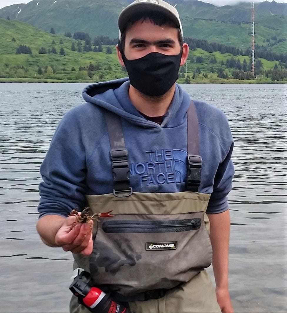 young man holding a crayfish