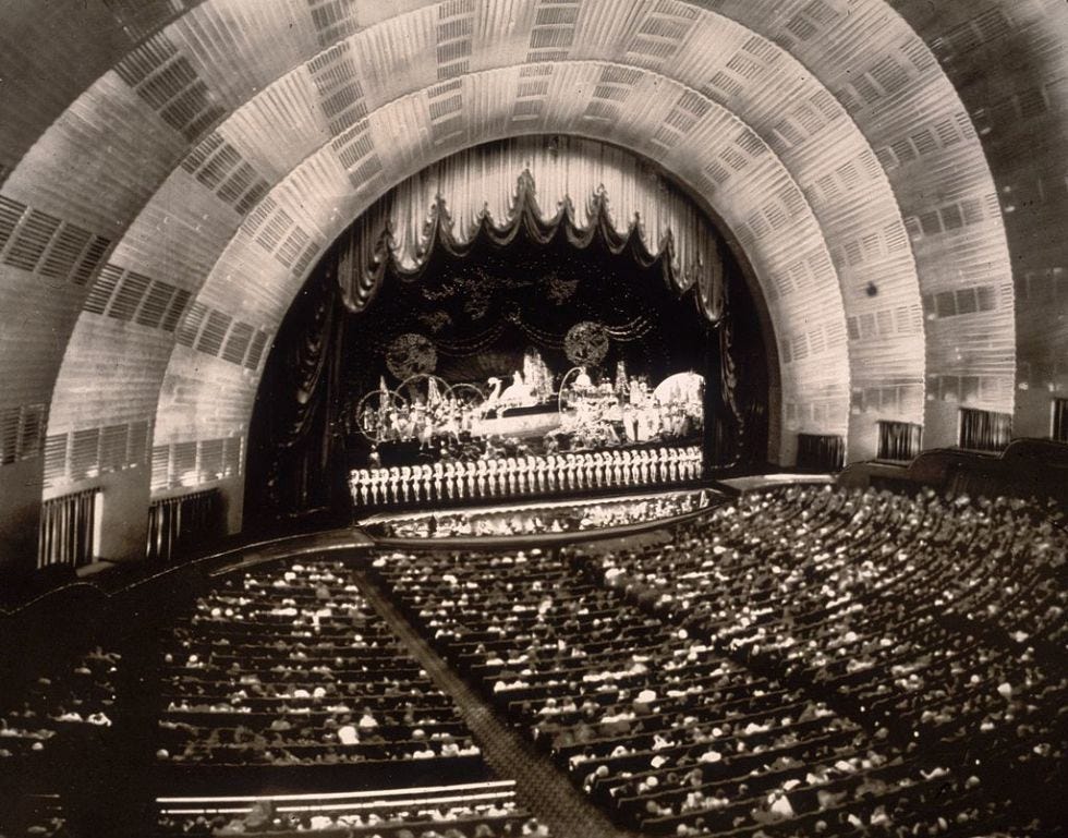 Roxy is credited with dreaming up the radiant sunrise stage that makes Radio City Music Hall so iconic today.