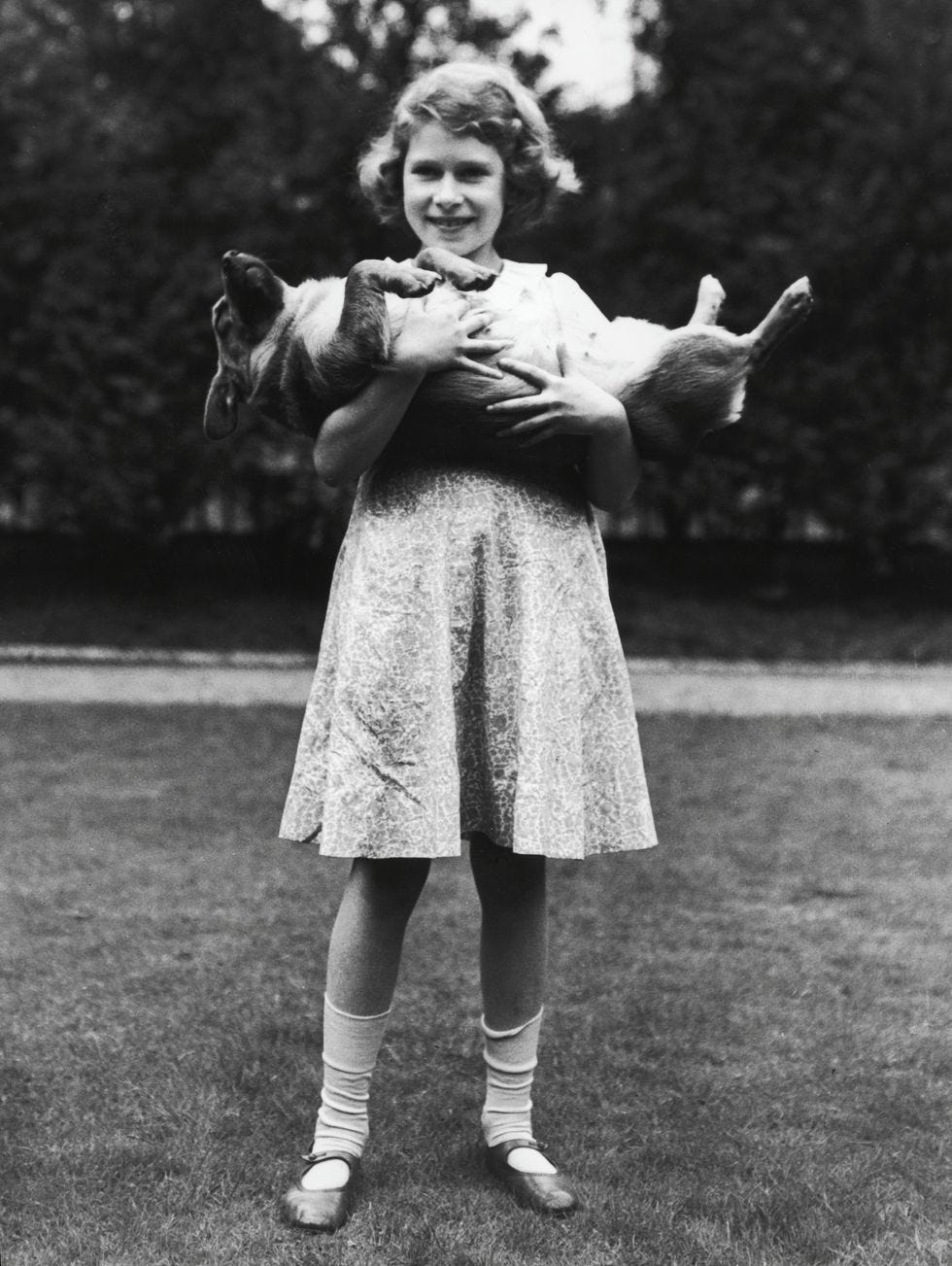 A young princess Elizabeth holding a corgi